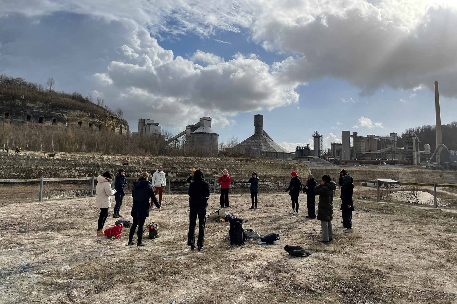 students from the Situated design master are standing in an industrial environment