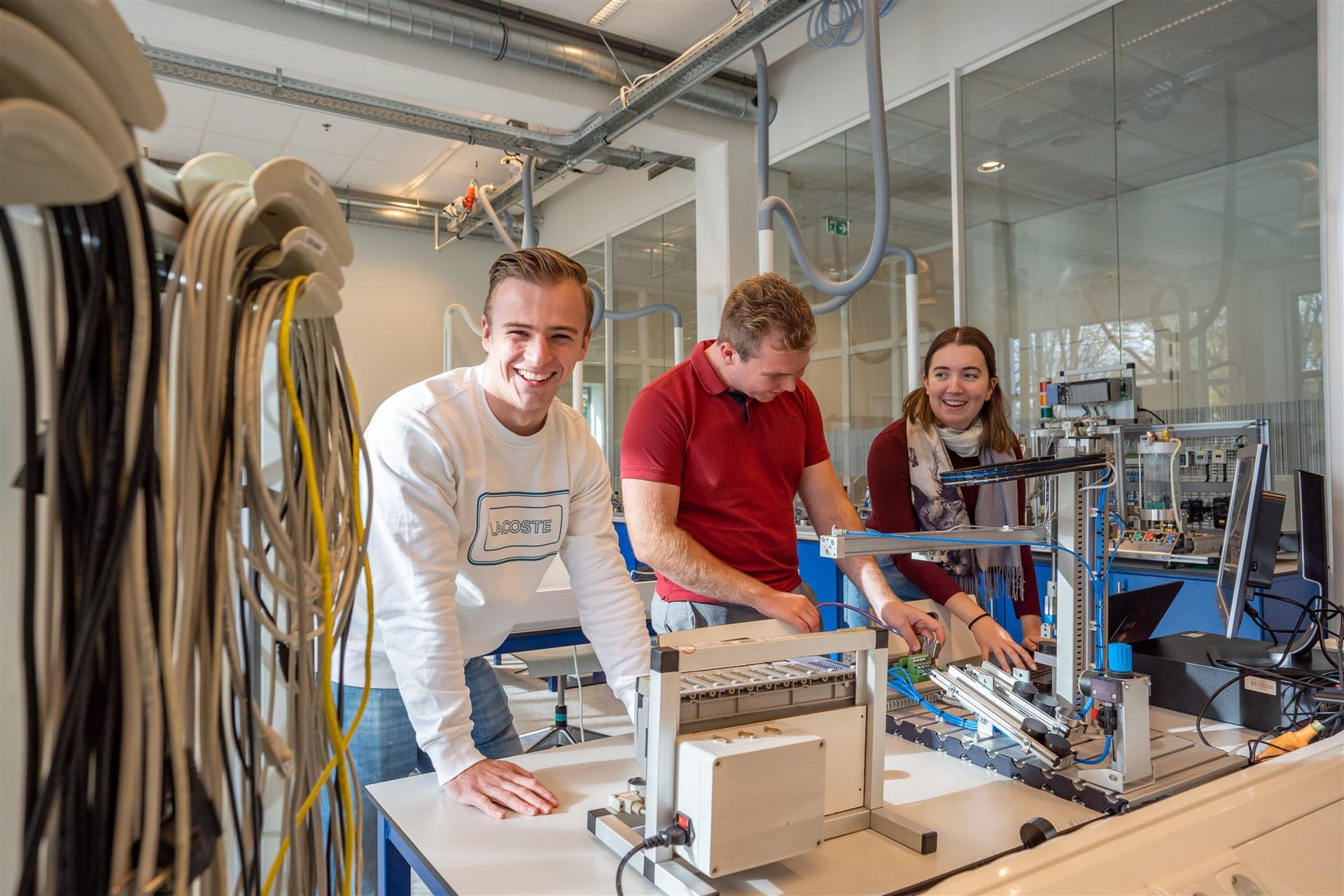 Mechatronica studenten zijn aan het werk met apparaten in een technische ruimte
